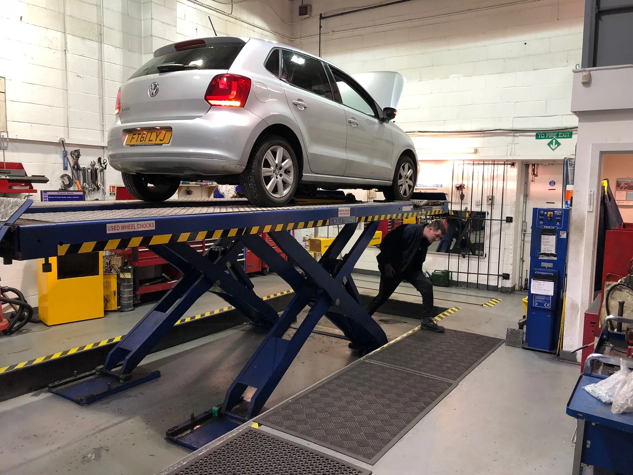 Silver Car on Ramp being Serviced