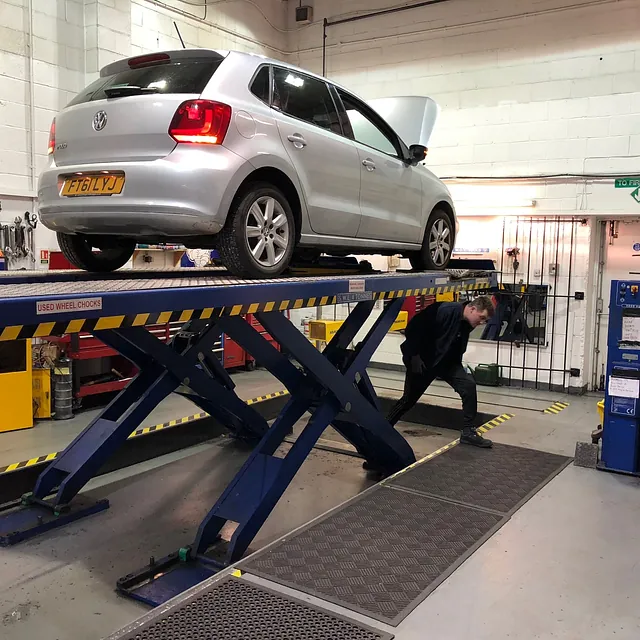 Silver Car on Ramp being Serviced